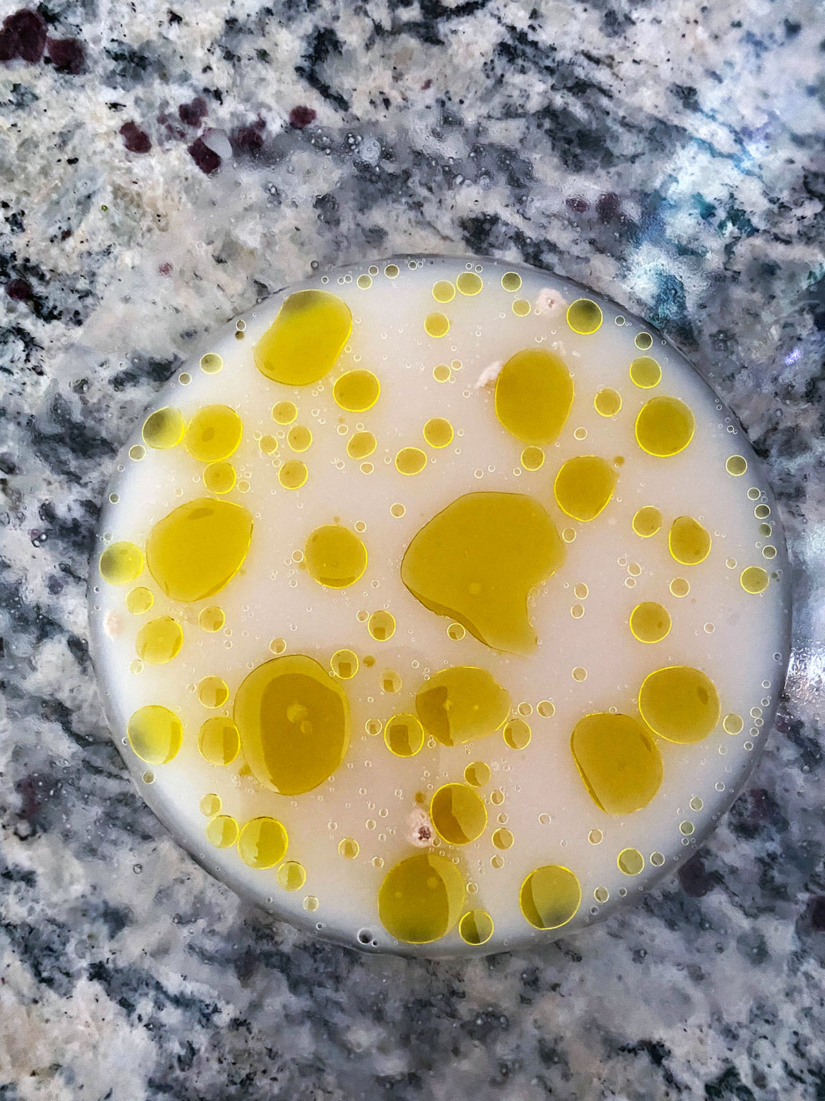 Yeast, oil, and water in bowl.