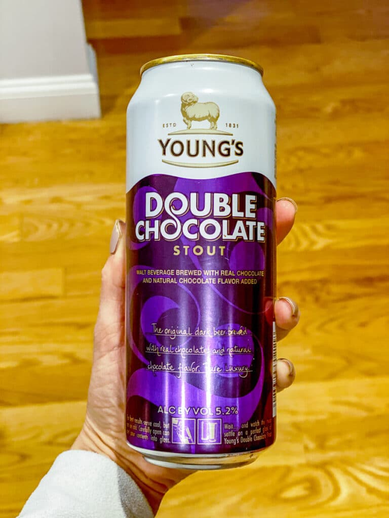 Hand holding a can of Young's Double Chocolate Stout