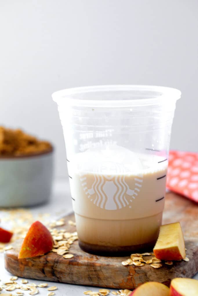 Apple brown sugar syrup with oatmilk in Starbucks cup.
