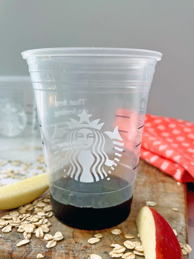 Apple brown sugar syrup poured into a Starbucks cup.