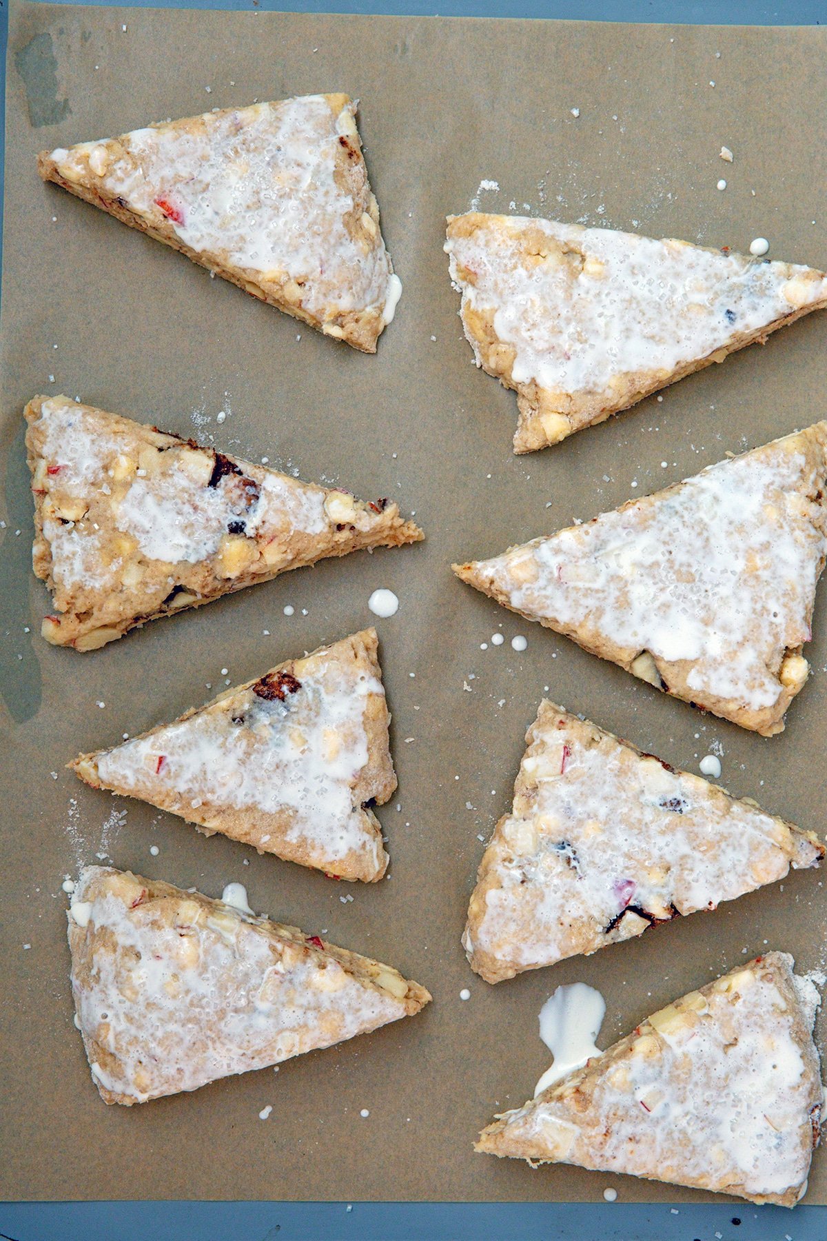 Scone dough cut out on baking sheet and brushed with milk.