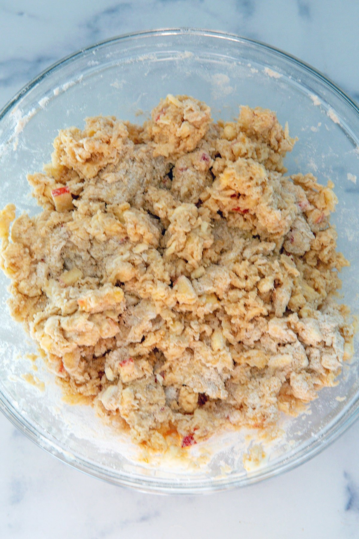 Apple cinnamon scone dough mixture in bowl.