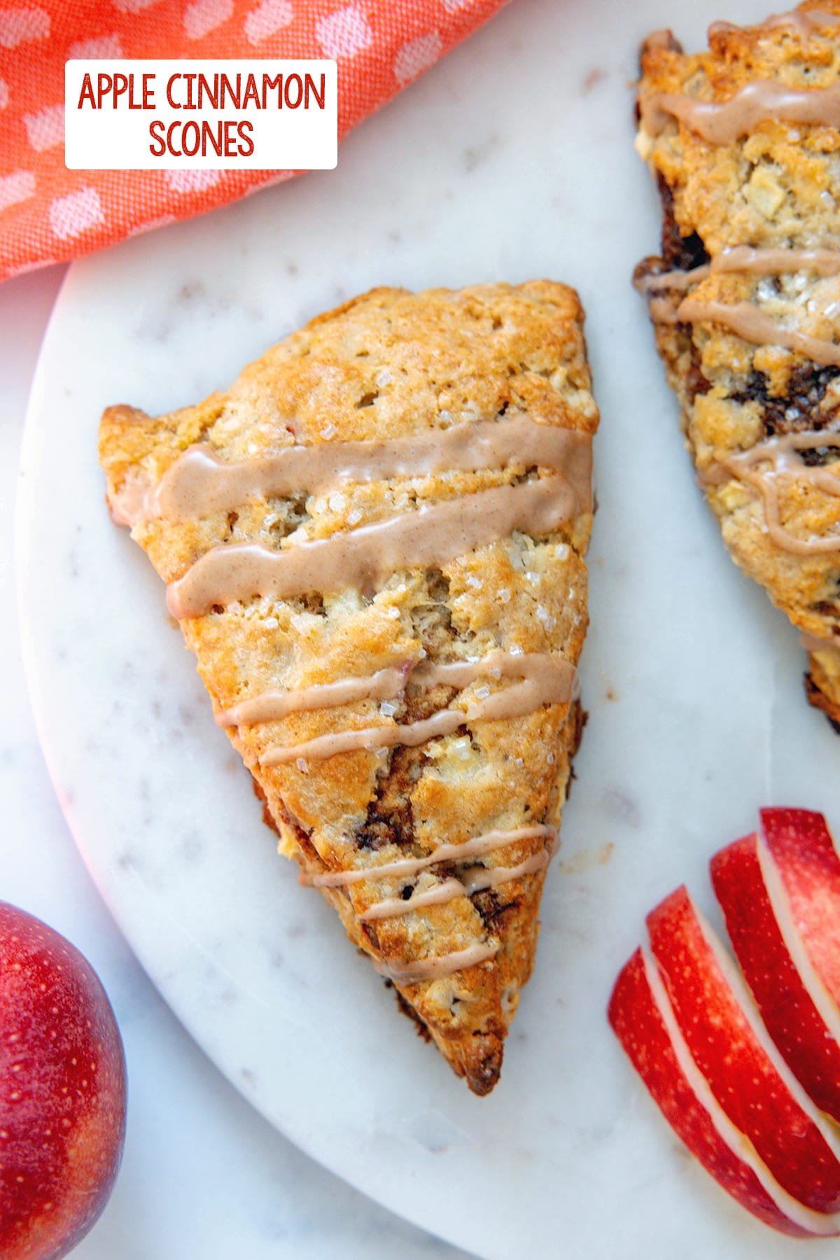Overhead view of an apple cinnamon scones with sliced apples and recipe title at top.
