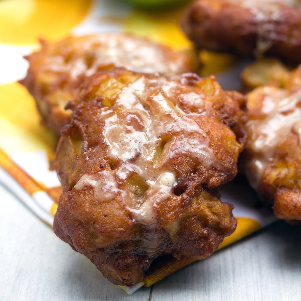 Closeup view of an apple fritter with icing.