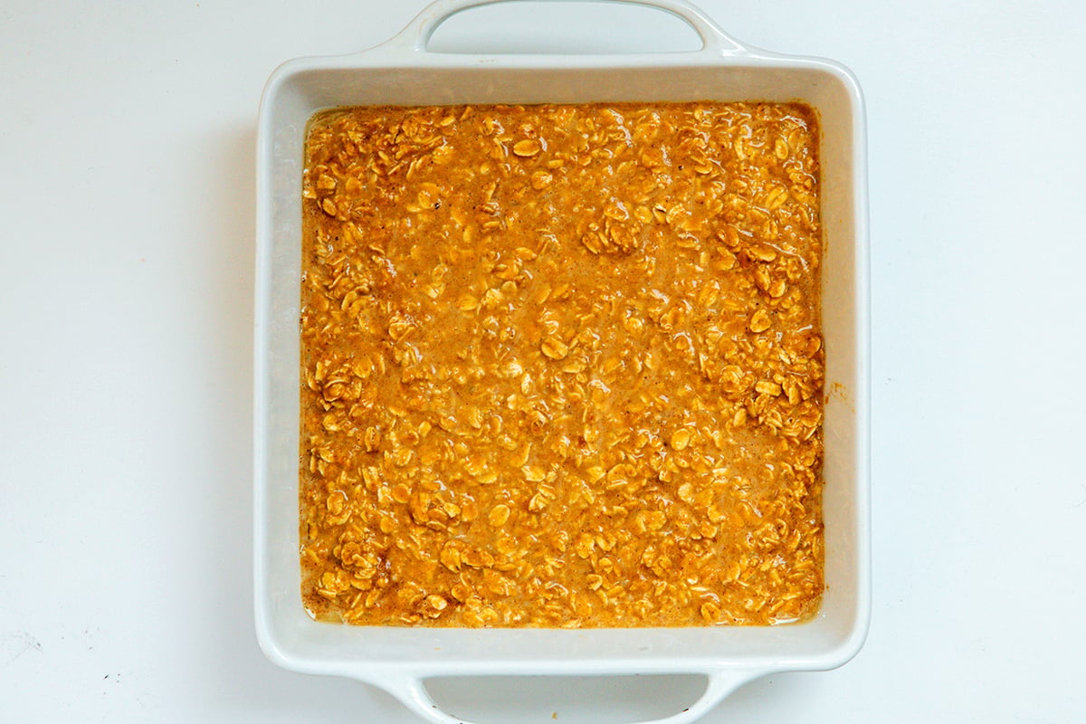Baked pumpkin oatmeal mixture poured into baking dish.