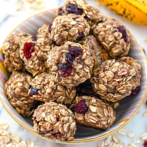 Overhead closeup view of banana maple cranberry cookies in a bowl.