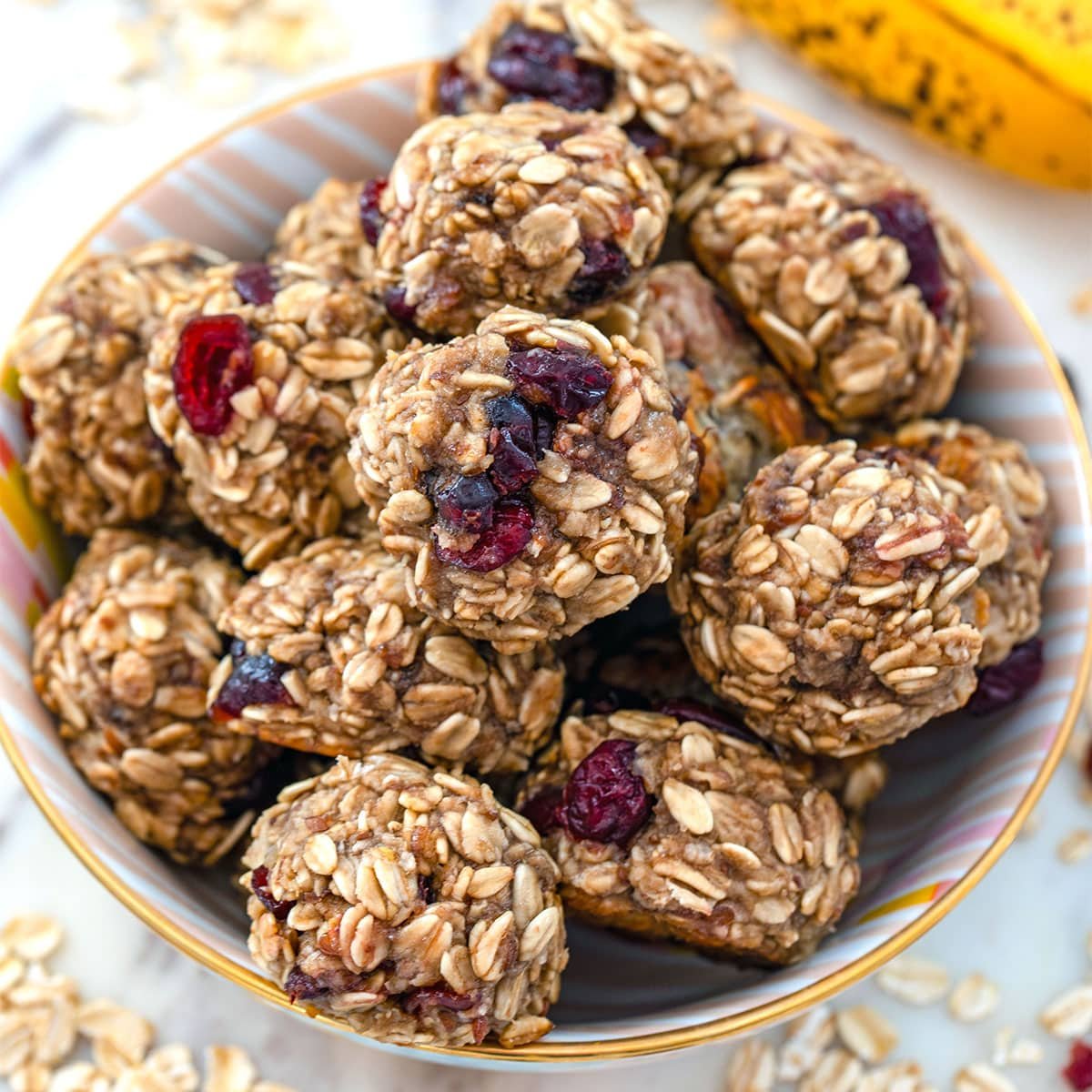 Overhead closeup view of banana maple cranberry cookies in a bowl.