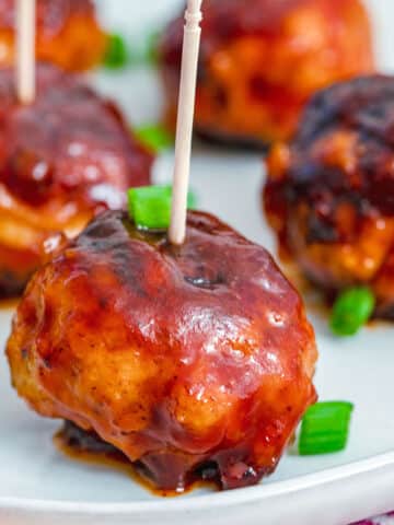 Closeup view of a BBQ chicken meatball with toothpick.