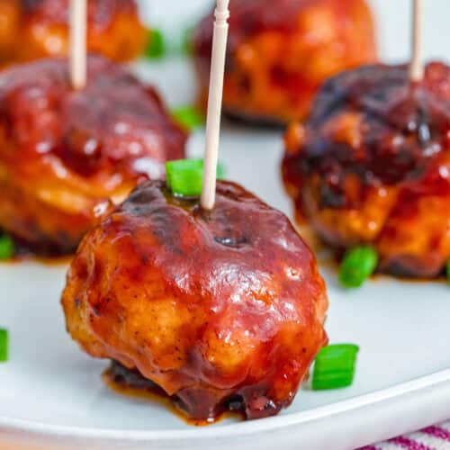 Closeup view of a BBQ chicken meatball with toothpick.
