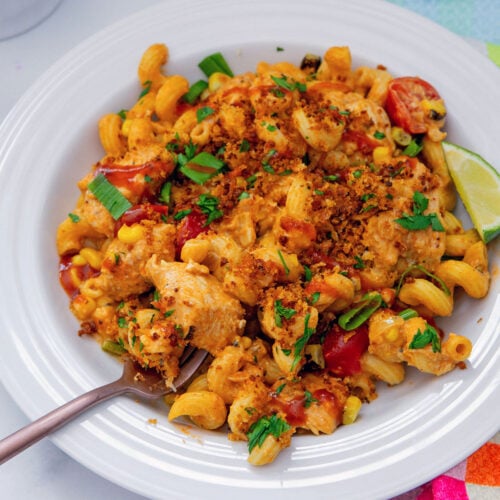 Closeup view of a plate of BBQ Chicken Pasta with fork.