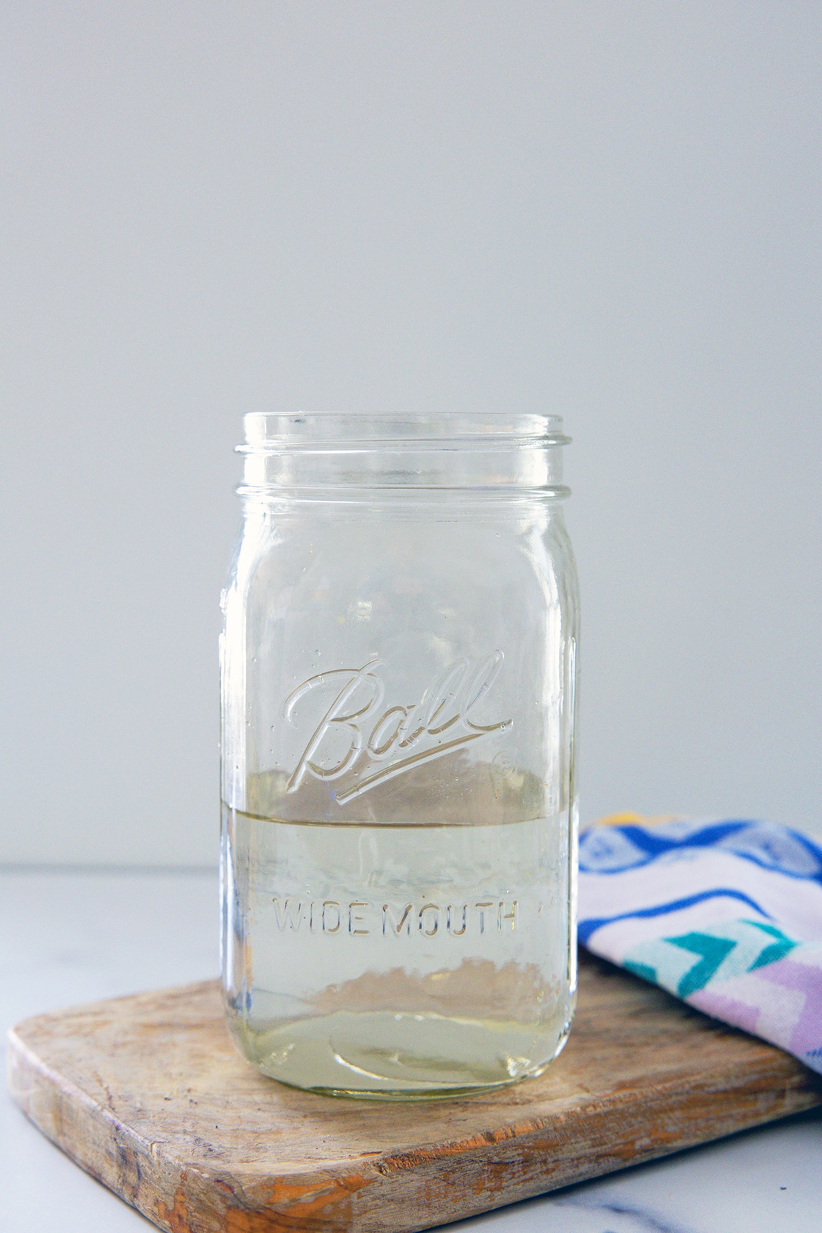 Berry syrup and water mixed together in large mason jar.