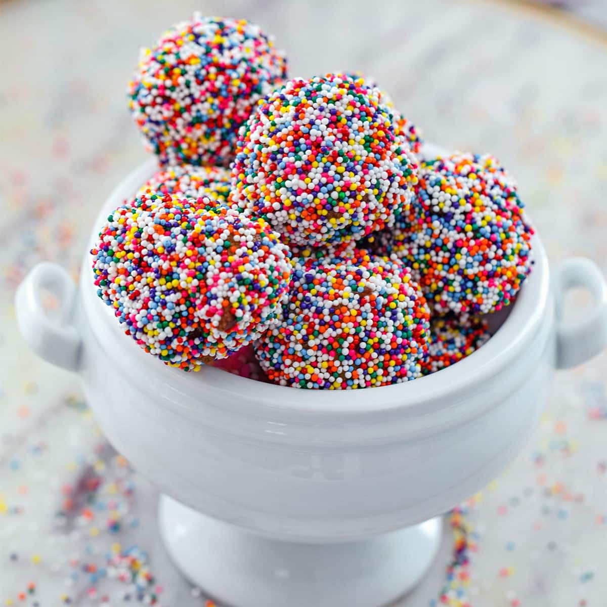 Closeup of birthday cake donut holes with lots of sprinkles.