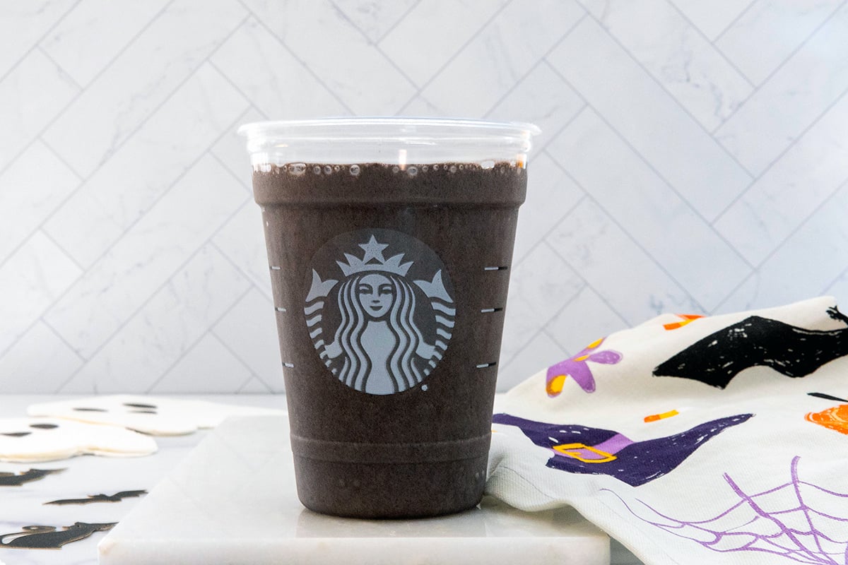 Landscape head-on view of a Black Cat Frappuccino in a Starbucks cup.