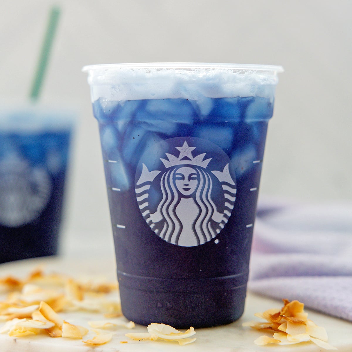 Closeup head-on view of a Blue Coconut Refresher in a Starbucks cup.