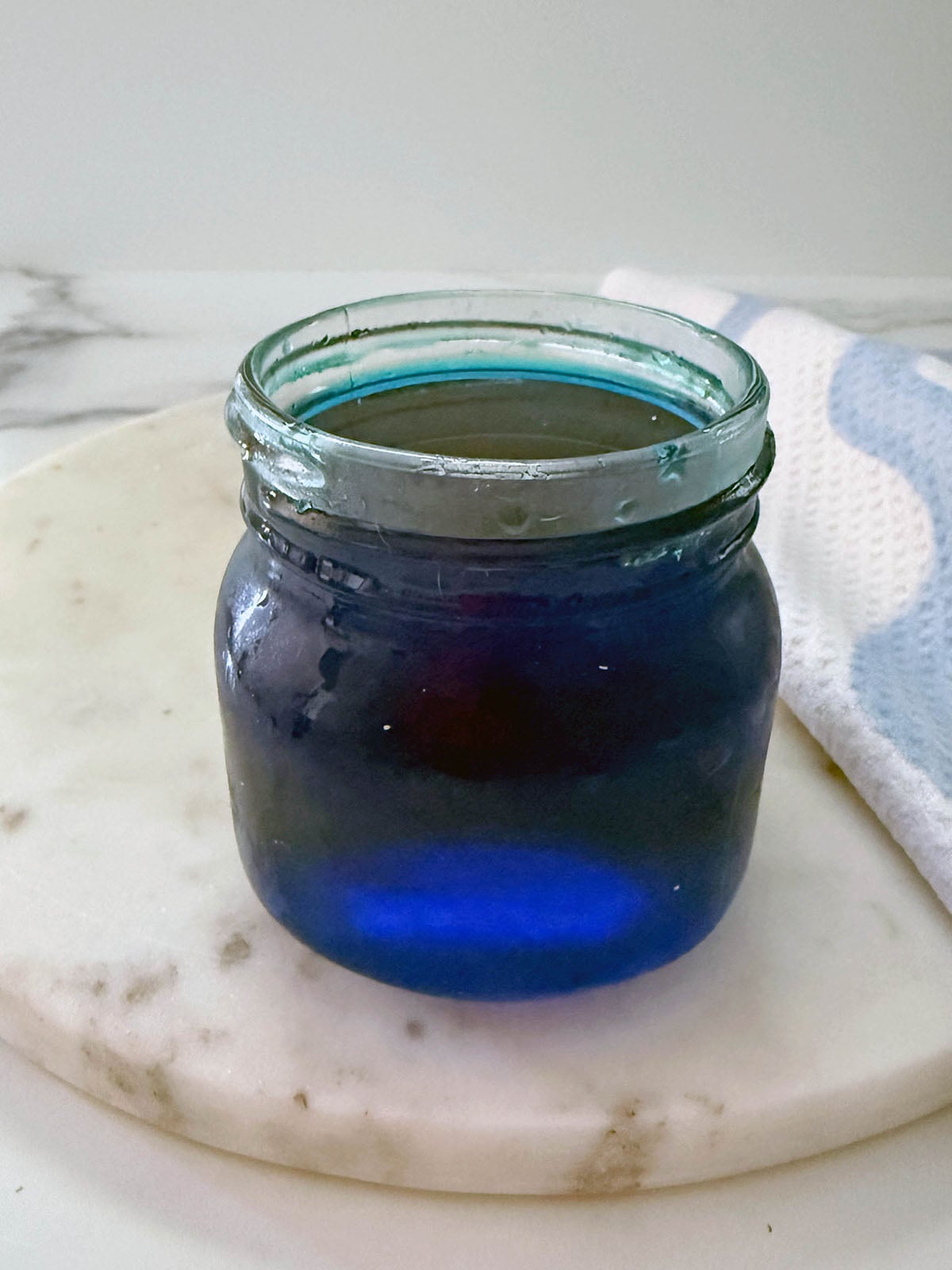 Blue coconut syrup in a small jar.