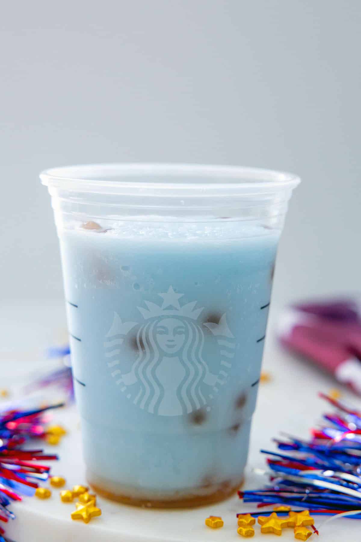 Head-on view of a blue Firework Frappuccino with raspberry boba pearls.
