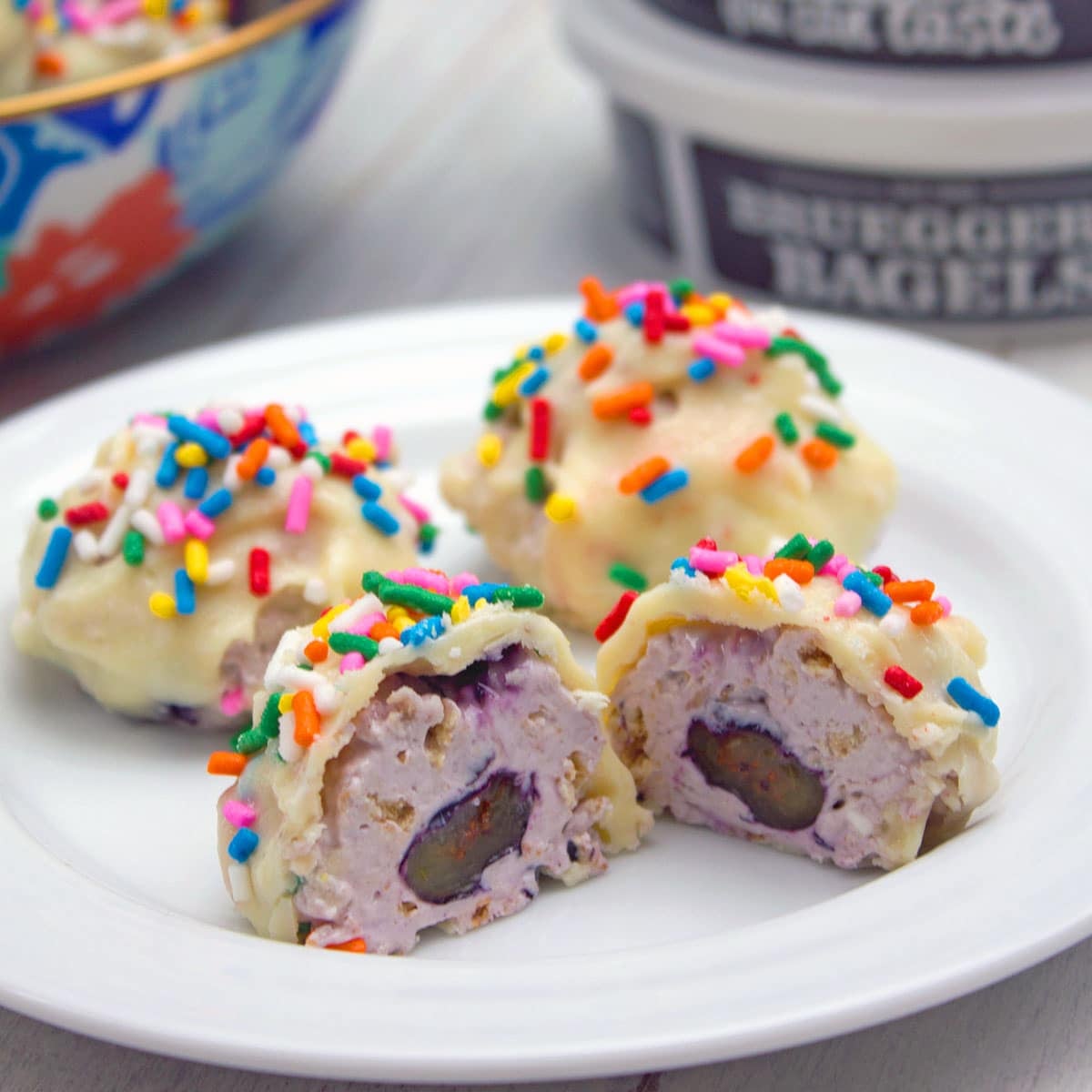 Closeup of blueberry greek cheesecake truffles with sprinkles.