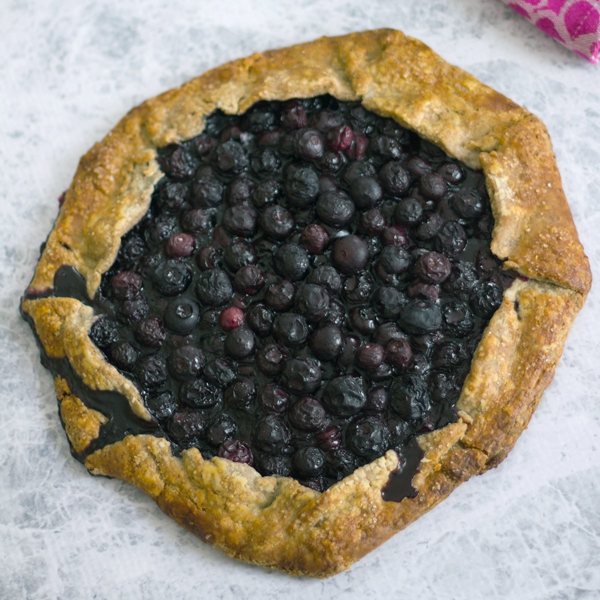 Closeup view of a blueberry pecan galette.