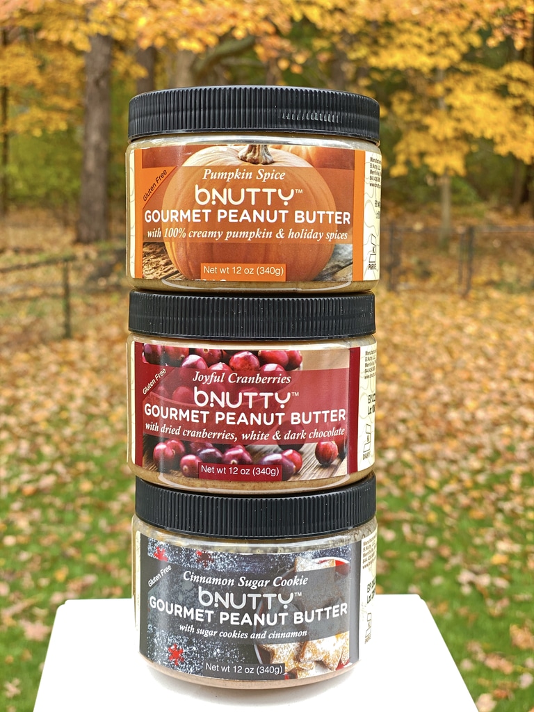 Stack of B.Nutty Peanut Butter in three flavors (pumpkin spice, cranberry, and cinnamon sugar cookie)