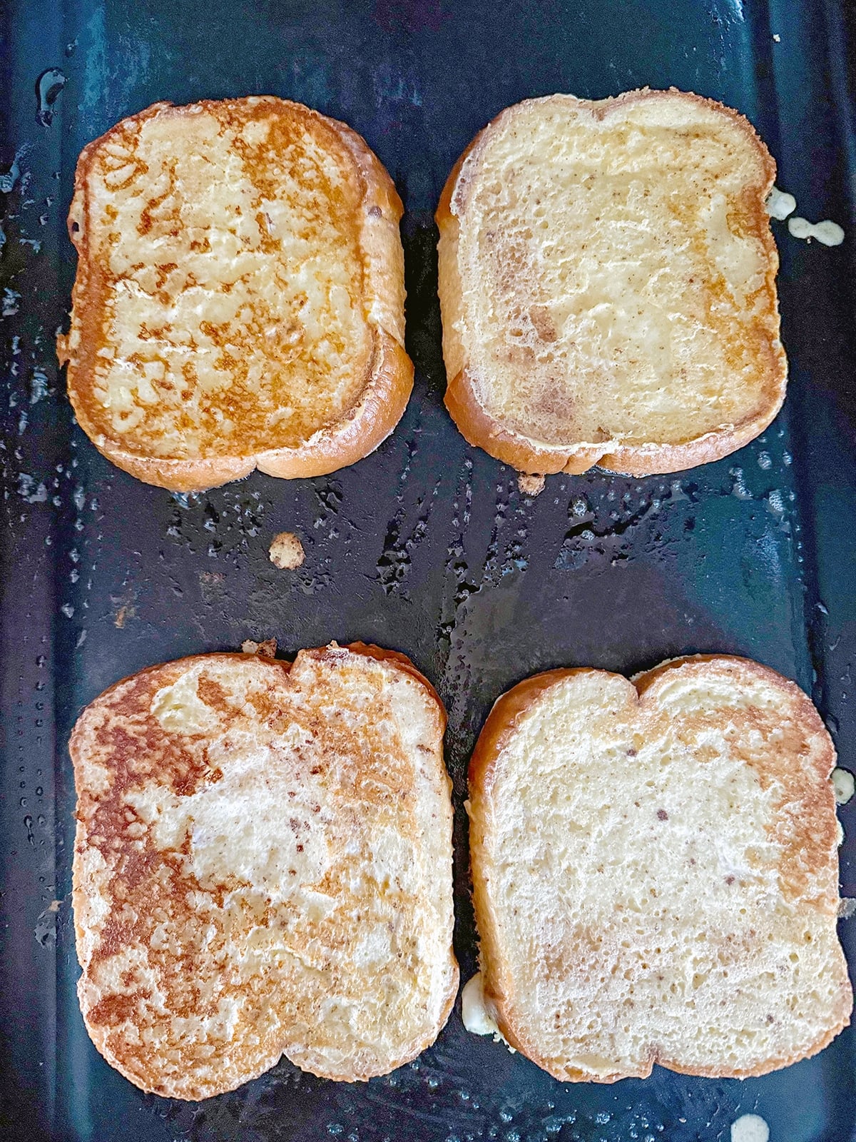 Buttermilk brioche turning golden on a griddle.