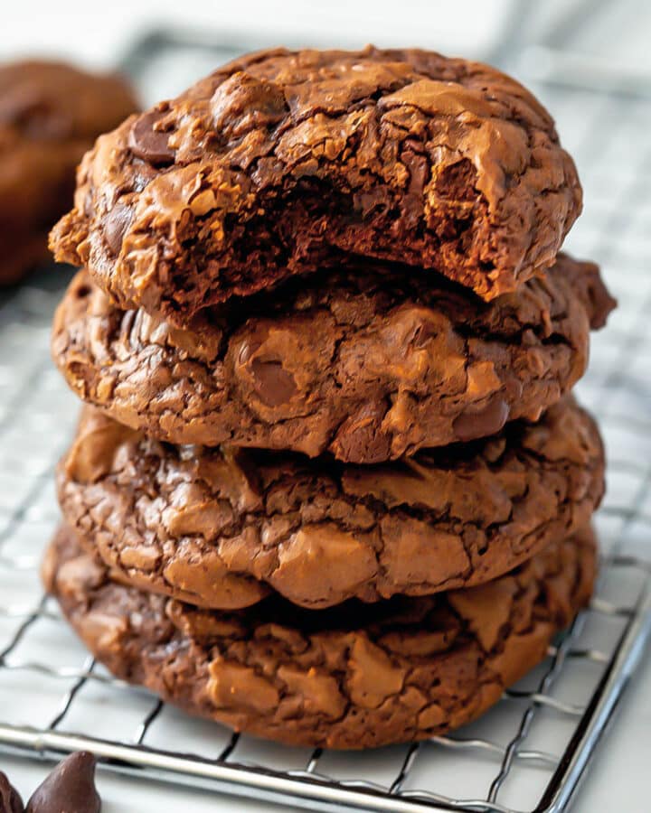 Close-up view of a stack of chocolate brownie mix cookies with a bite taken out of the top one.