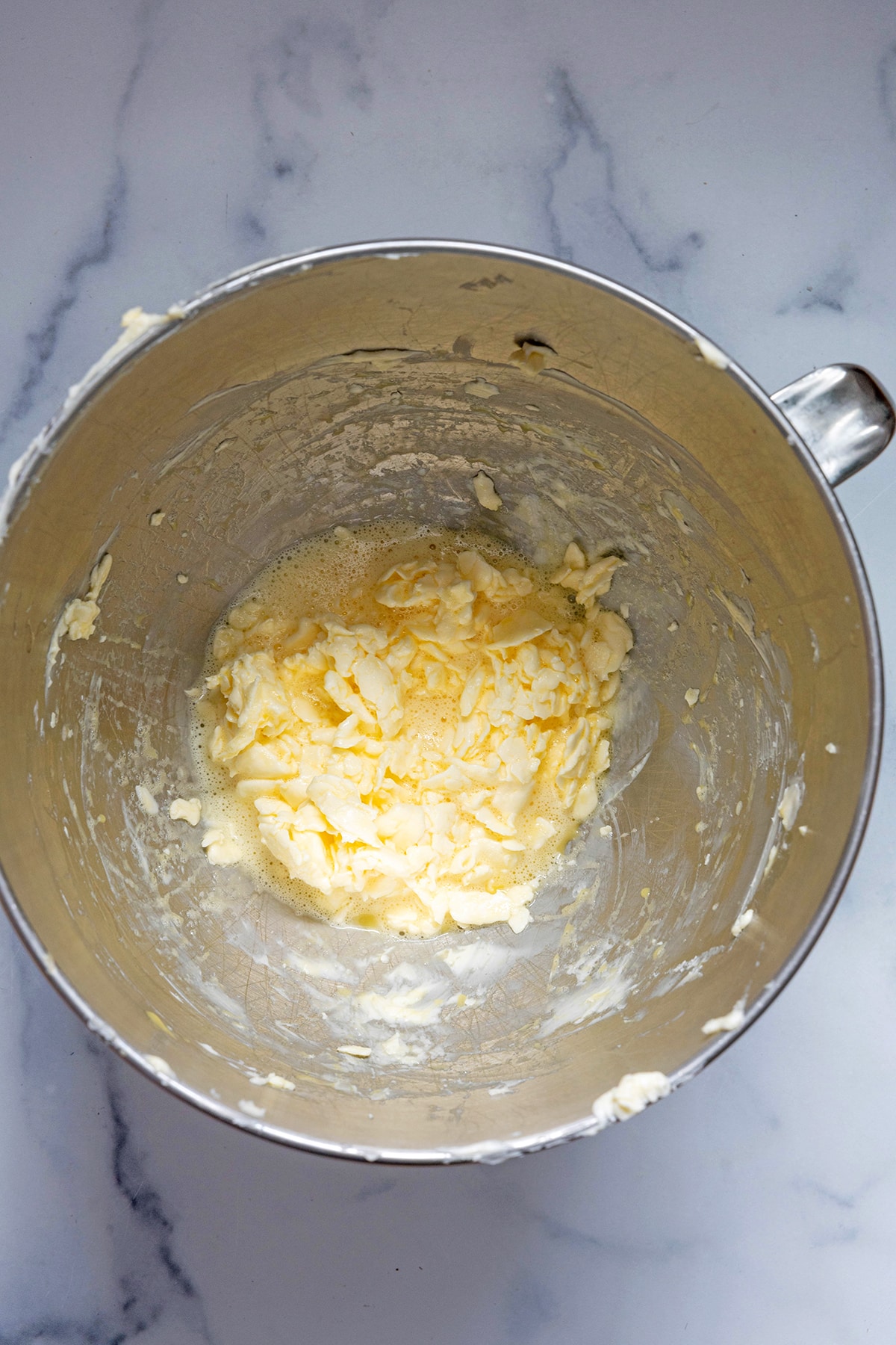 Creamed butter and eggs in mixing bowl.