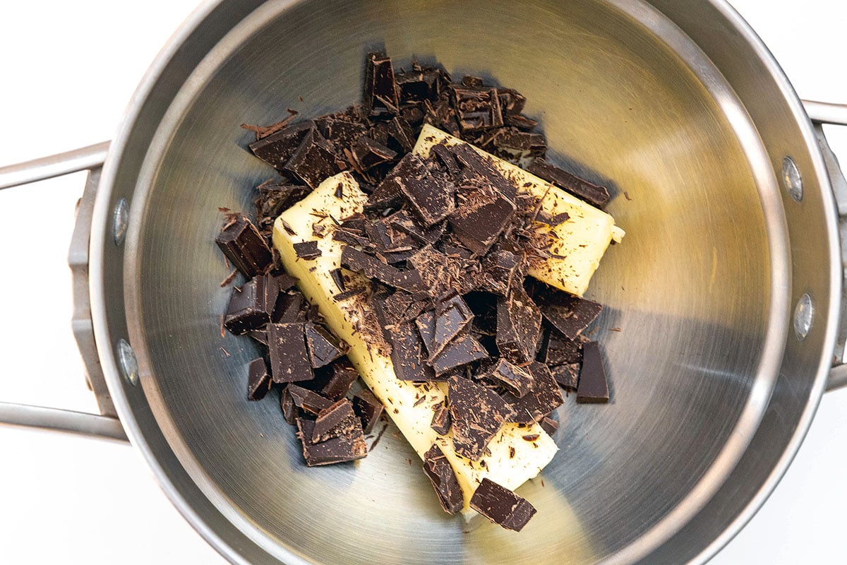 Landscape view of butter and chopped chocolate in double boiler.