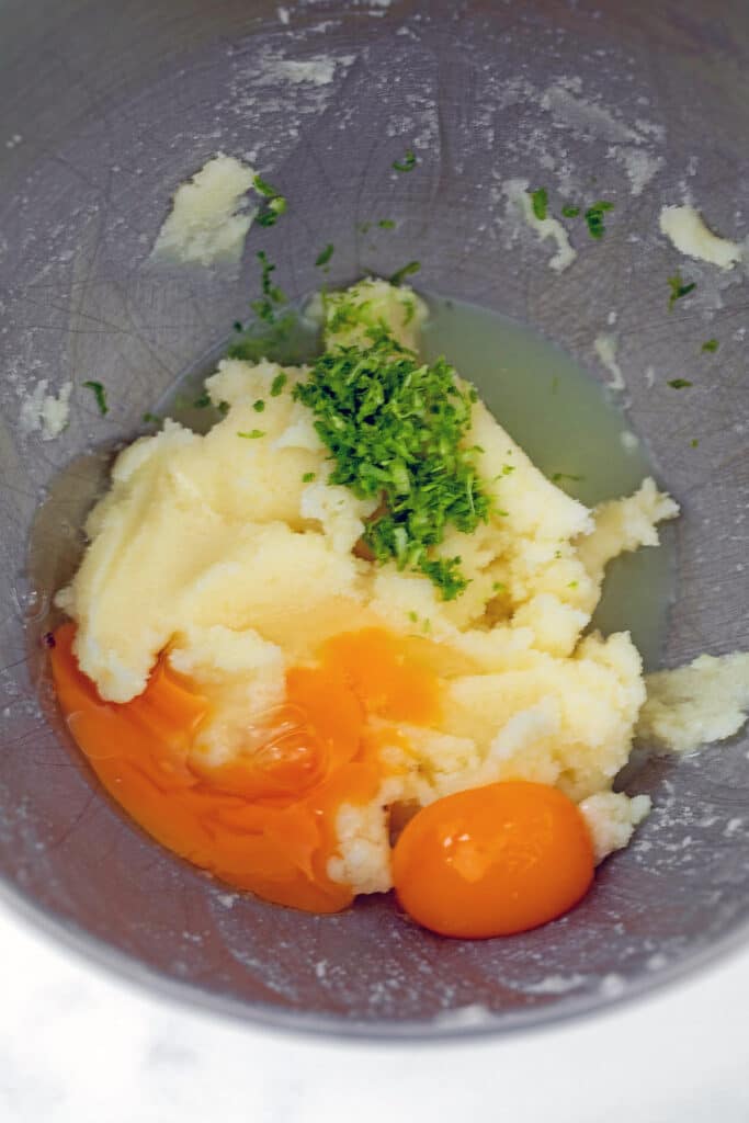 Butter and sugar creamed together in mixing bowl with eggs and lime zest.