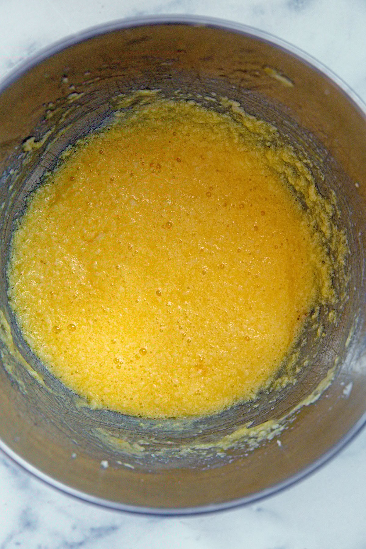 Butter, sugar, and eggs in mixing bowl.