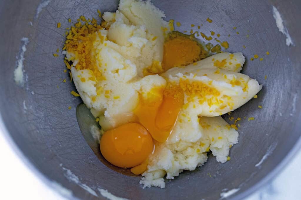 Butter ans sugar creamed together with eggs, lemon zest, and lemon juice in mixer bowl.