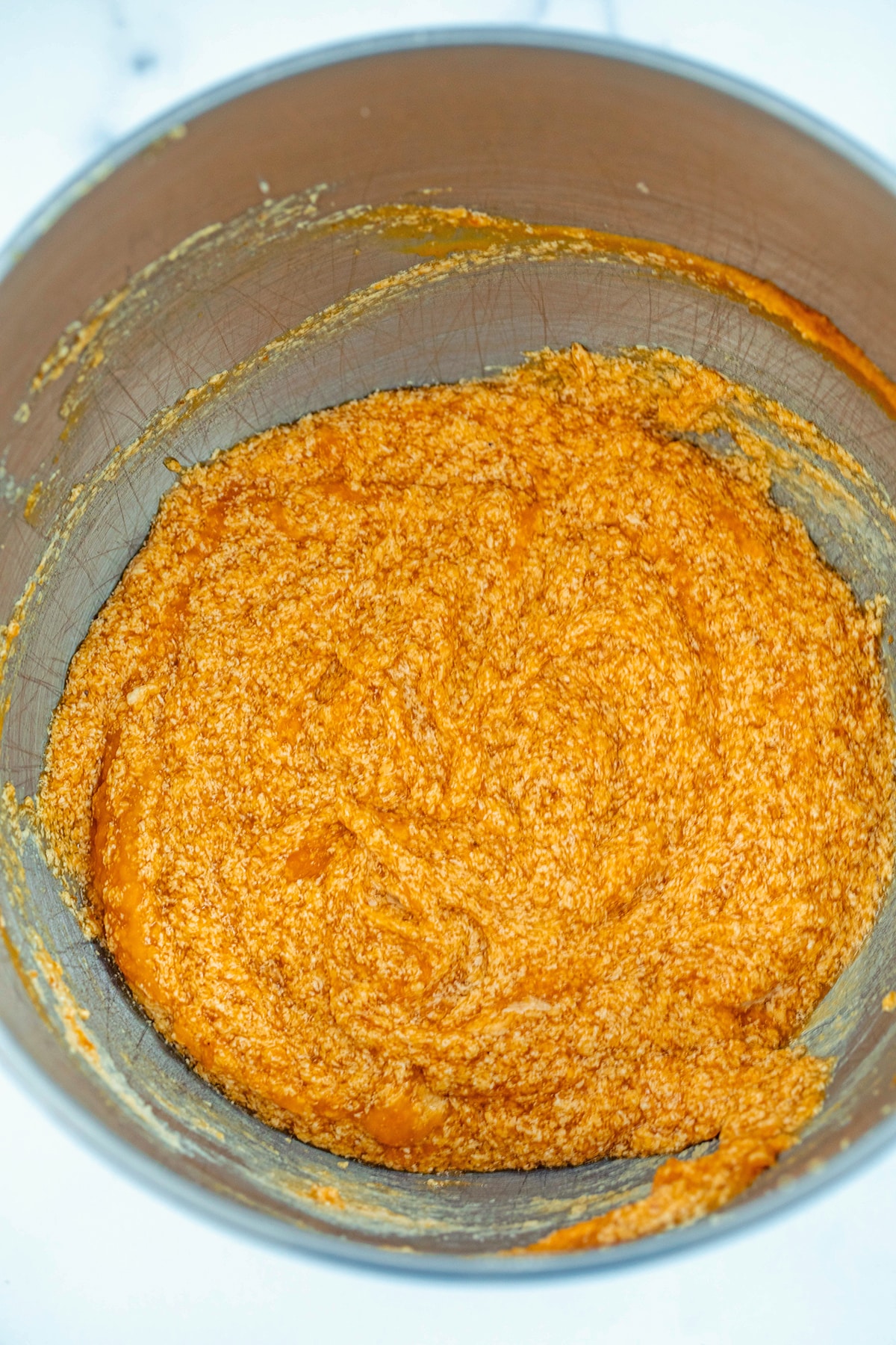 Butter, sugars, and pumpkin puree in mixing bowl.