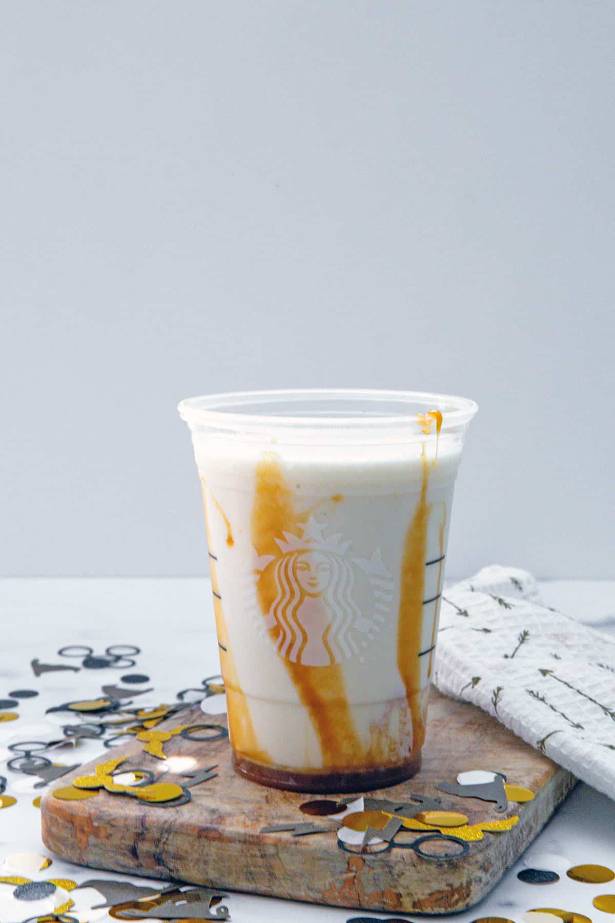 Butterbeer Frappuccino poured into caramel-lined Starbucks cup.