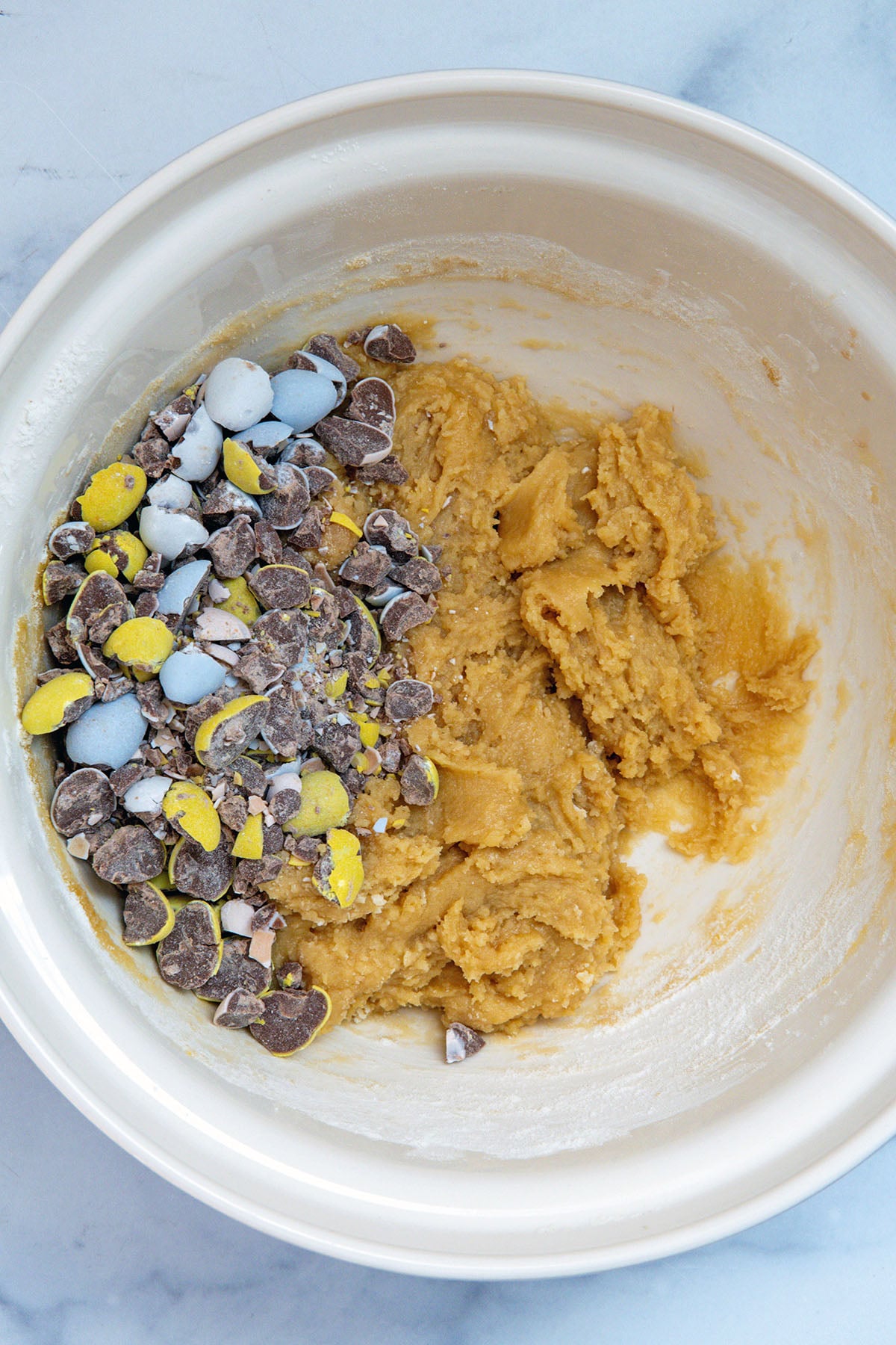 Mixing bowl with blondie batter and chopped Cadbury Mini Eggs.