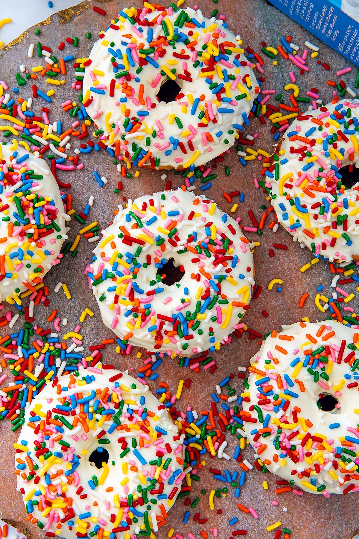 Closeup overhead view of cake mix donuts with rainbow sprinkles.