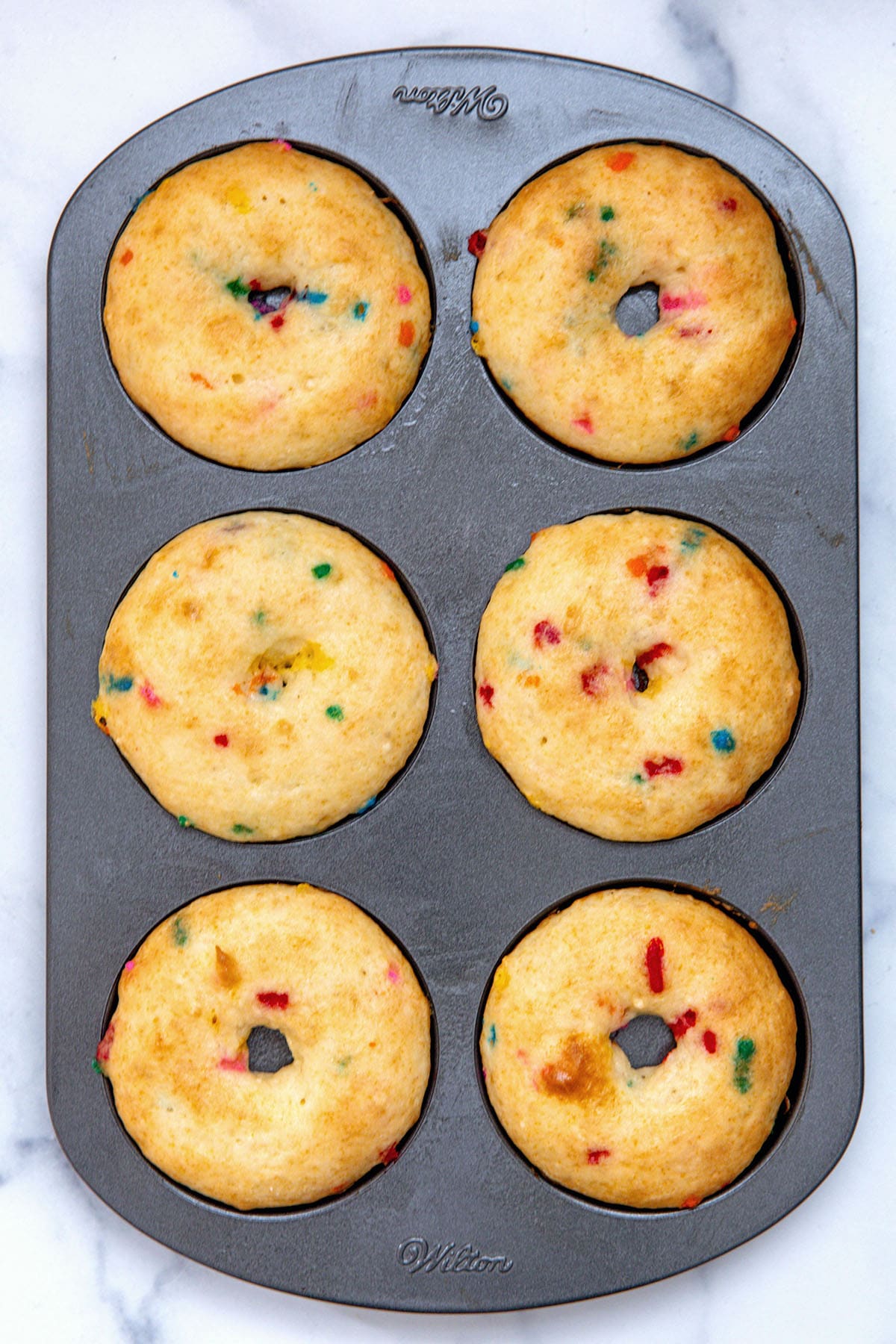 Funfetti cake mix donuts baked in donut pan.