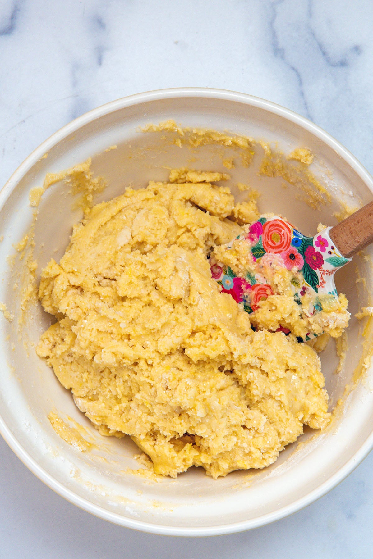 lemon cake mix cookie dough in a bowl with spatula.