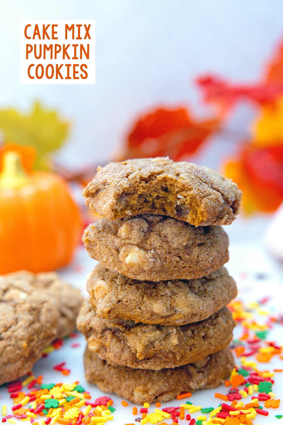 Head-on view of a stack of cake mix pumpkin cookies with sprinkles all around and recipe title at top.