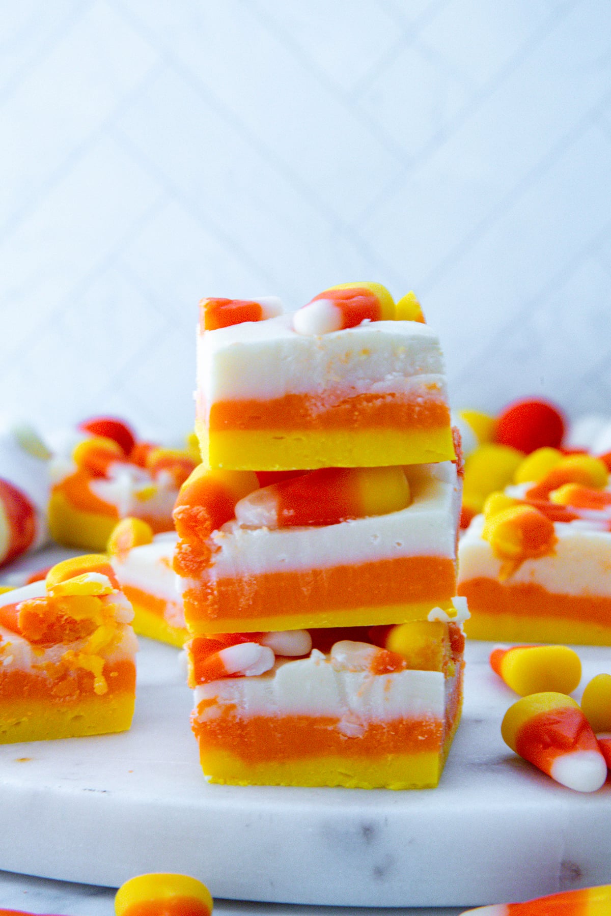 Stack of yellow, orange, and white candy corn fudge.