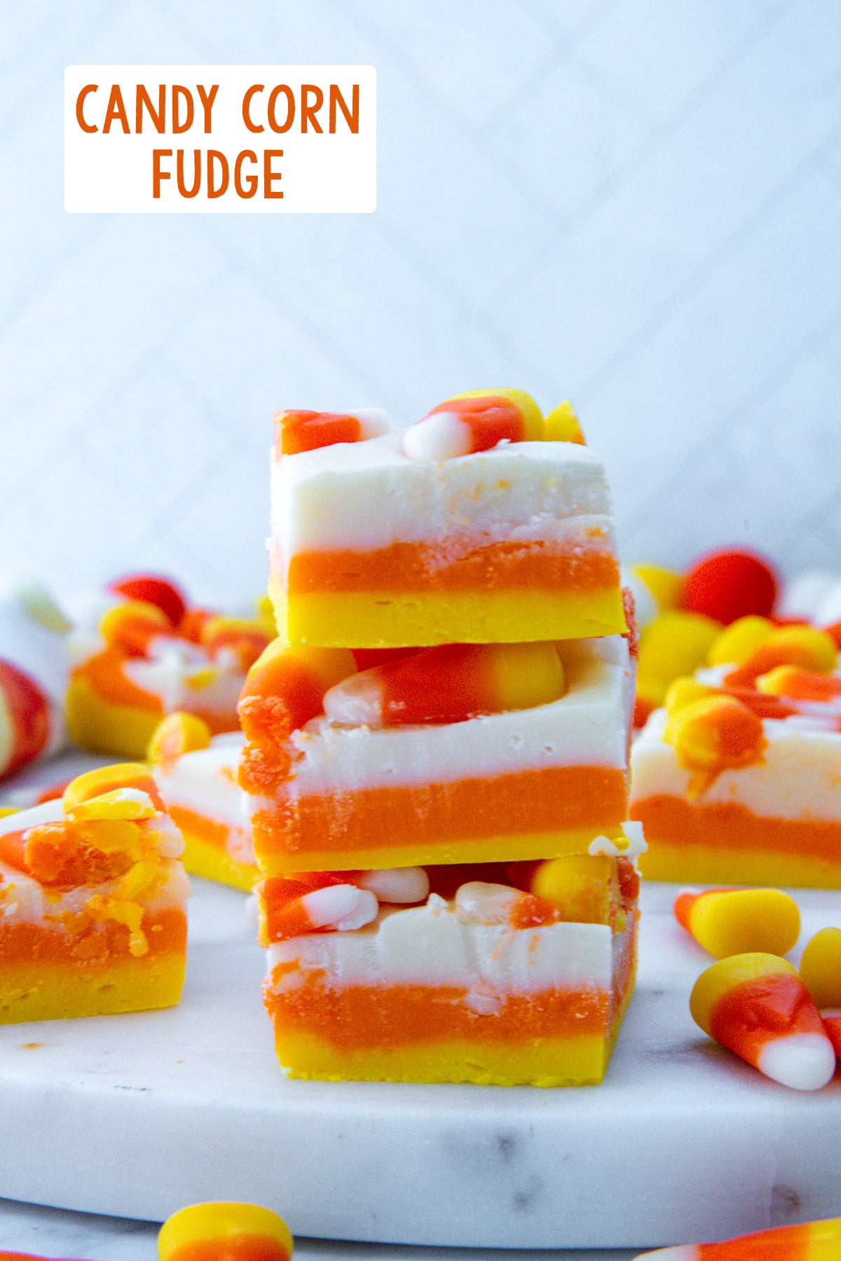 Stack of yellow, orange, and white candy corn fudge with recipe title at top.