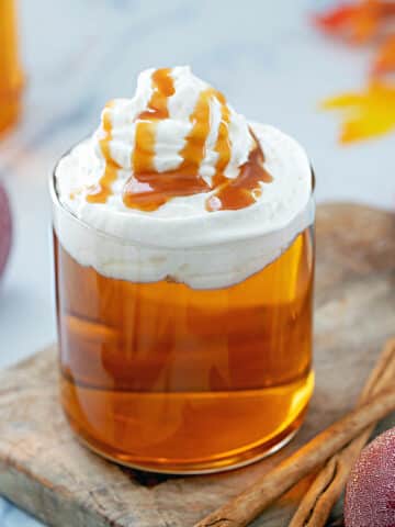 Close-up view of a Caramel Apple Spice with whipped cream and caramel drizzle.