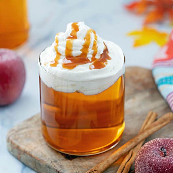 Close-up view of a Caramel Apple Spice with whipped cream and caramel drizzle.