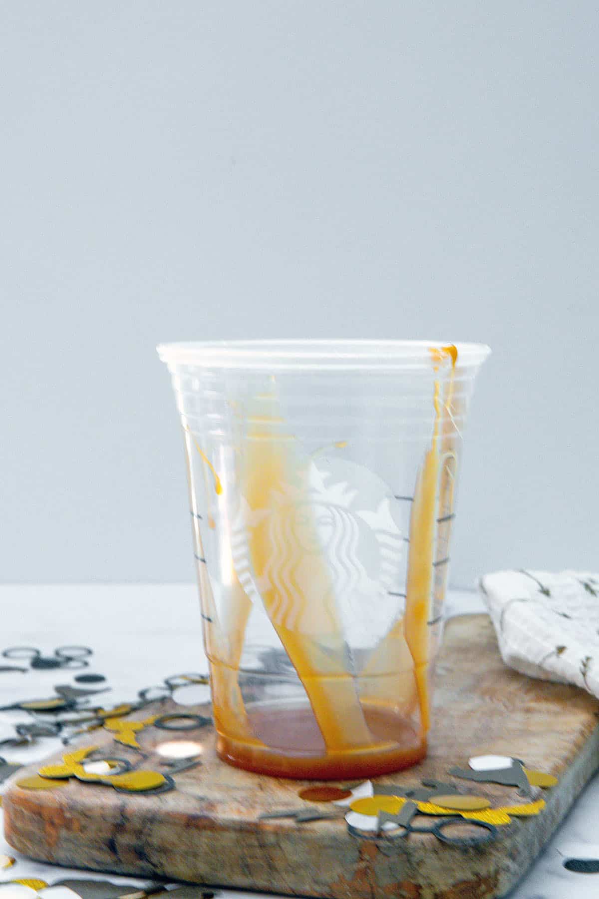 Starbucks cup lined with caramel sauce.