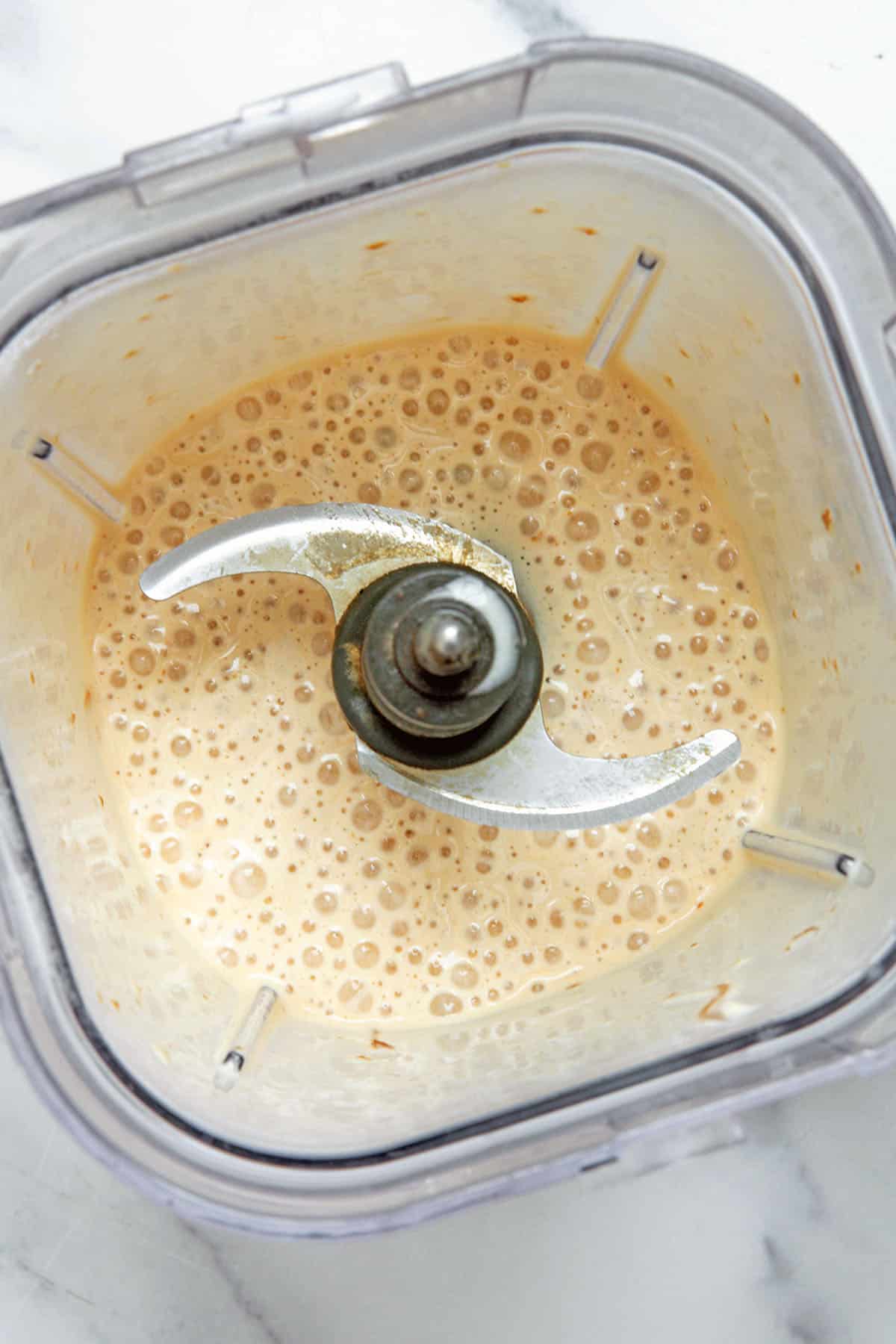 Overhead view of Caramel Ribbon Crunch Frappuccino base blended together in blender.