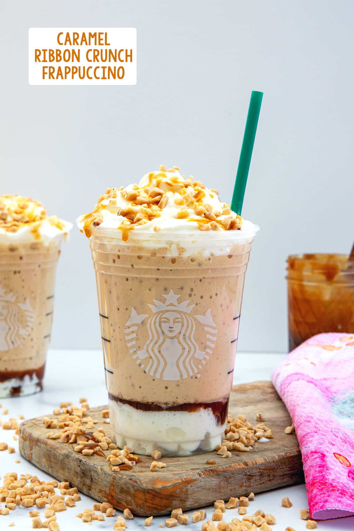 Head-on view of a Caramel Ribbon Crunch Frappuccino with whipped cream and recipe title at top.
