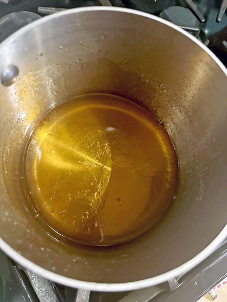 Caramel syrup in saucepan.