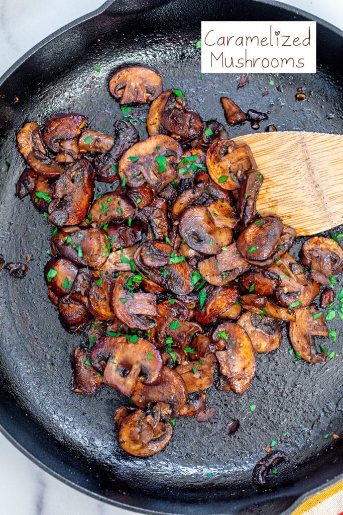 Caramelized mushrooms with parsley in cast iron skillet with recipe title at top.