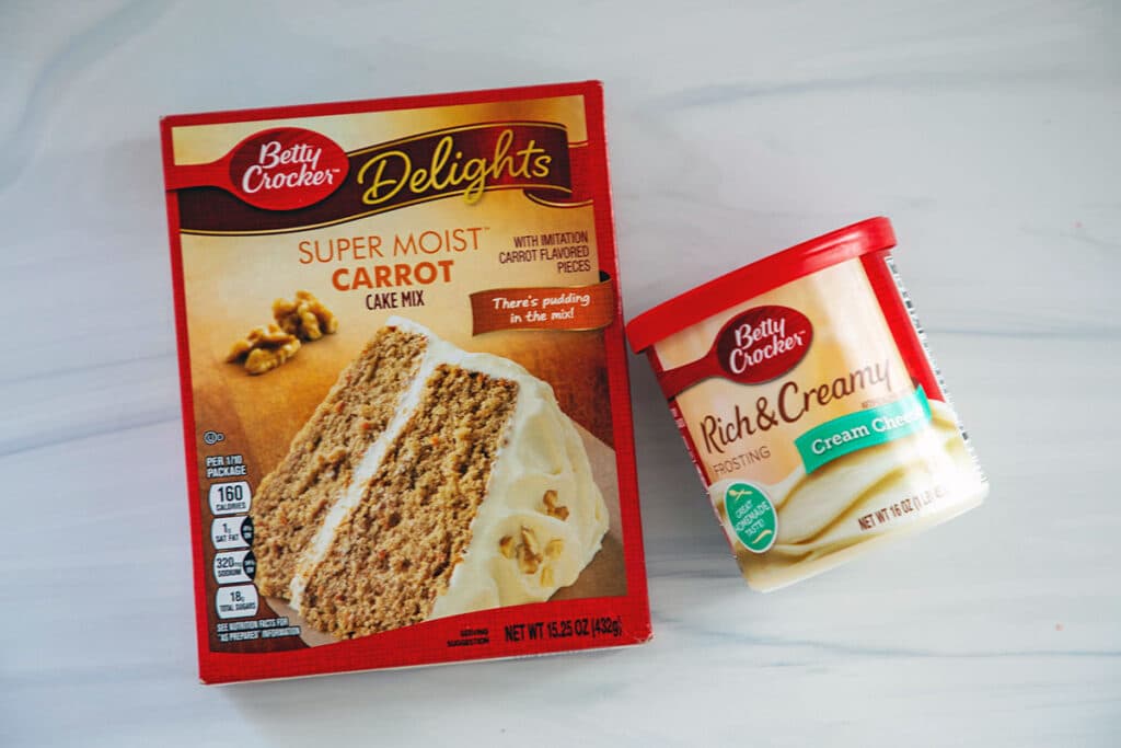 box of carrot cake and container of cream cheese frosting.