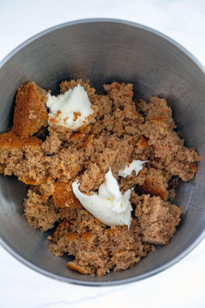 Carrot cake and cream cheese frosting in mixing bowl.