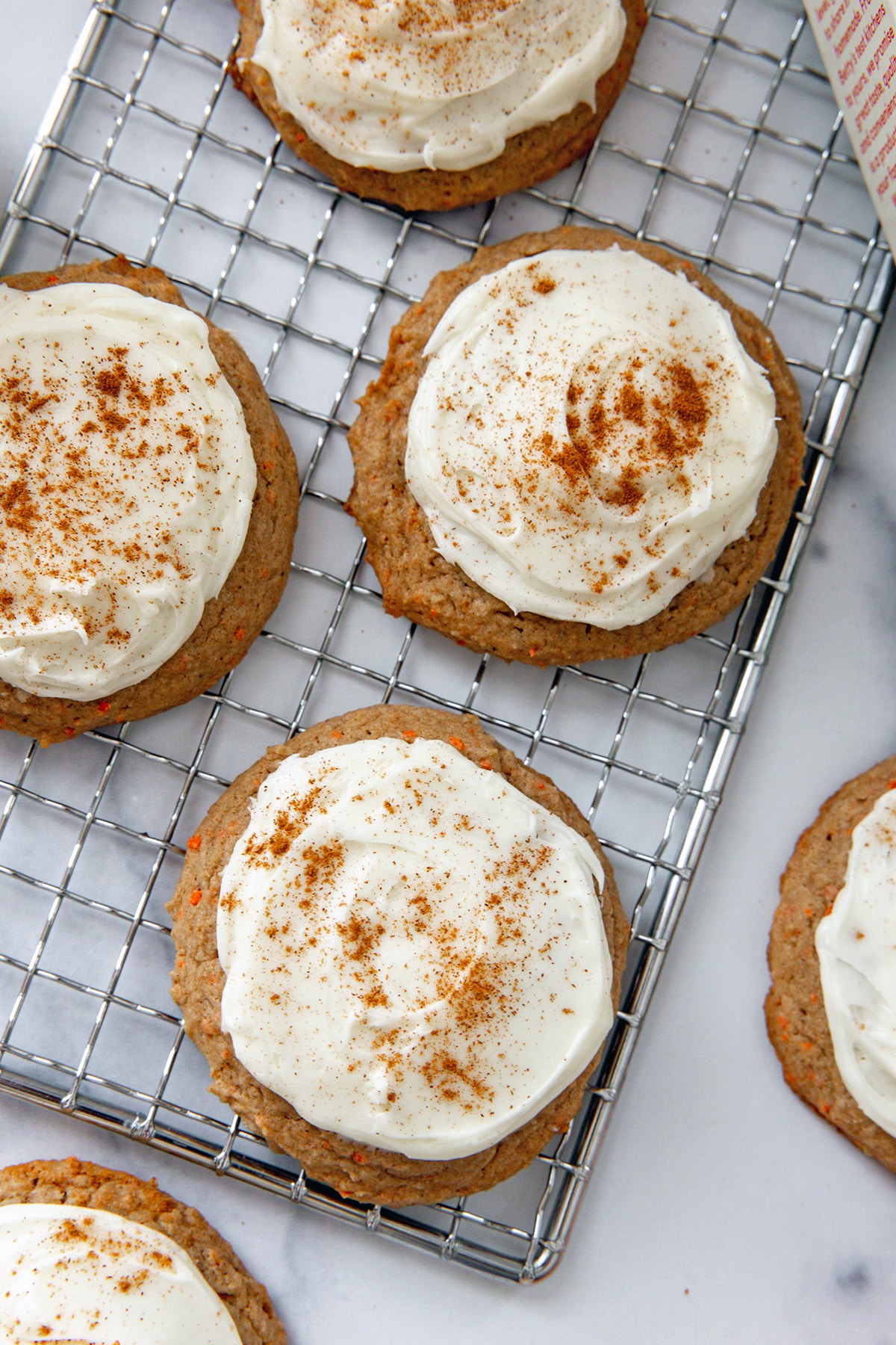 Carrot cake mix cookies topped with cream cheese frosting and cinnamon.