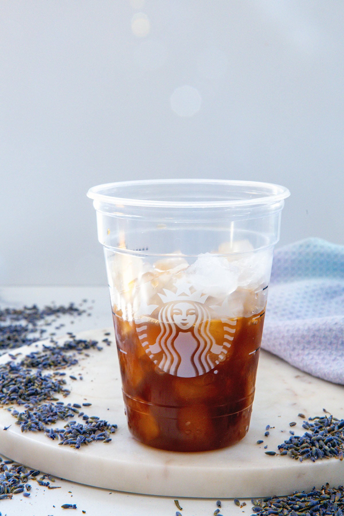 Chai concentrate in a Starbucks cup with ice.
